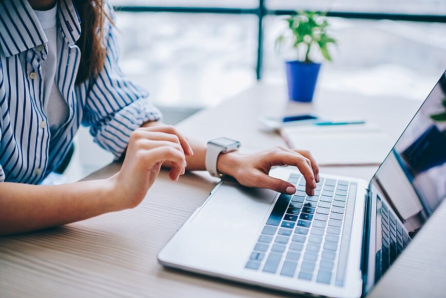 Une jeune femme travaille sur un ordinateur portable